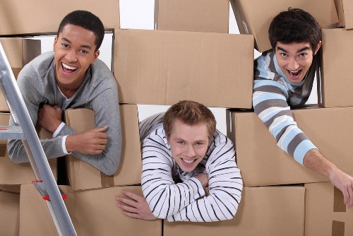 Moving team managing boxes and furniture in Farringdon